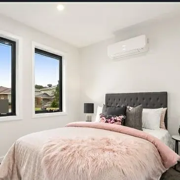 Split system air conditioner on a bedroom wall