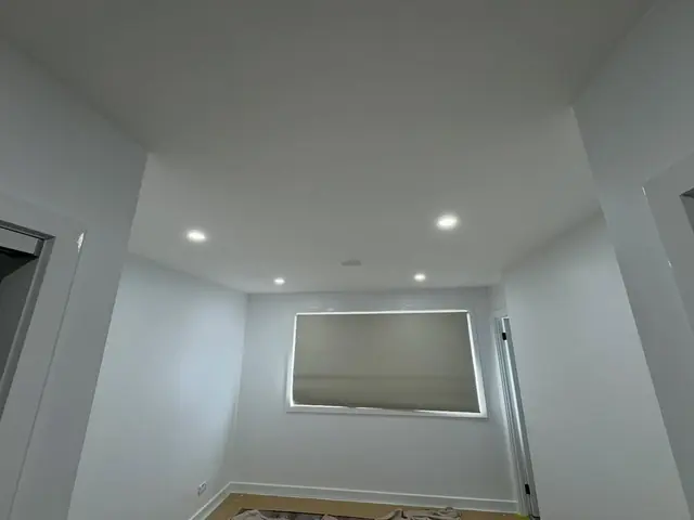 Room with new recessed LED downlights in the ceiling