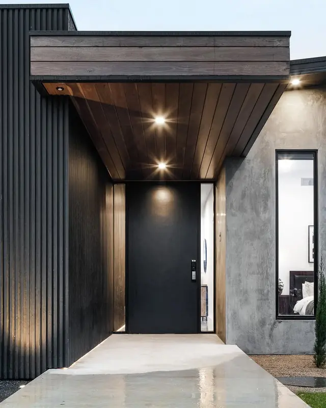 Downlights in a timber-lined front entry canopy above the front door