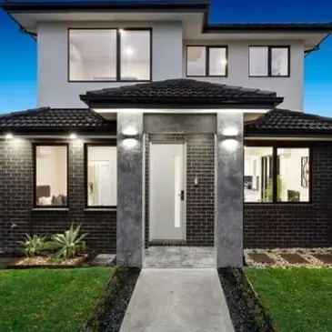 House facade with wall lights on the front pillars