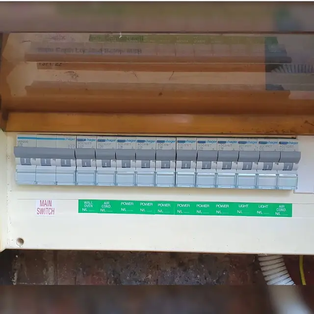 Hager switchboard with a row of labelled circuit breakers and a main switch