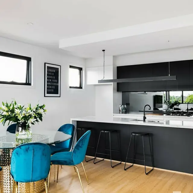 Kitchen and dining area with a linear pendant and recessed downlights