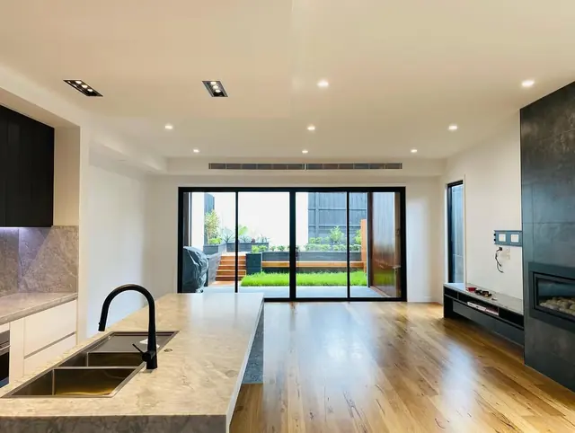 Open-plan kitchen and living area with recessed downlights