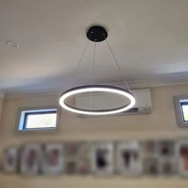 Ring LED pendant light hanging in a living room